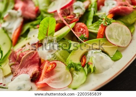 Salad of meat, vegetables and herbs. Food from the chef in a restaurant or cafe.