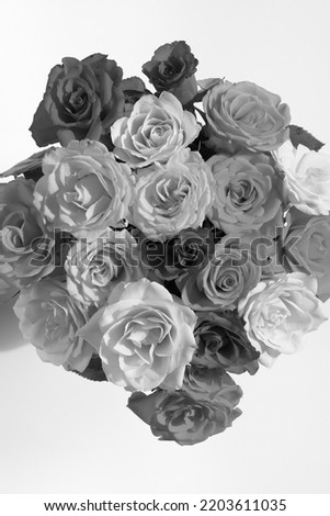 Black and white shot of a lush, artistically arranged bouquet of roses