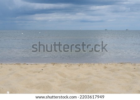 view from the beach to the sea.  The worderful and wild bech. Sea, sand and sky. Panorama of beautiful sandy beach and blue water Summer vacation beach background. Sea wave on the sandy beach. 