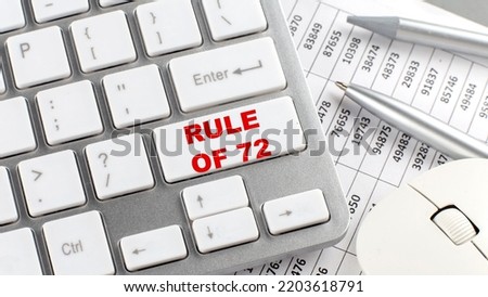 RULE OF 72 text on keyboard wirh chart and pencil Royalty-Free Stock Photo #2203618791