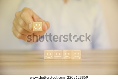 positive customer reviews Tap the wooden block, happiness icon and five-star smiley face. Satisfaction survey concept, opinions, customer service The best response from the user experience of the prod