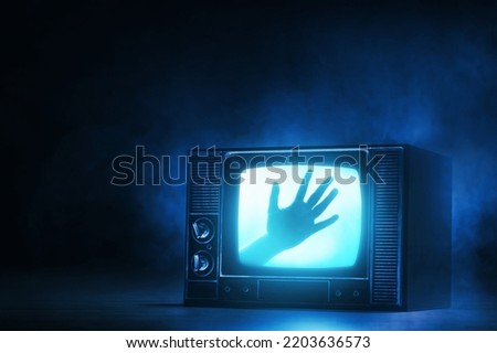 Watching horror movie on tv Royalty-Free Stock Photo #2203636573