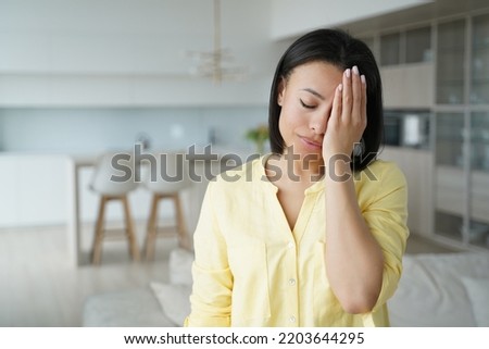 Facepalm, oh no. Upset female with hand on head feel sorrow regret blaming herself for failure, mistake, standing at home. Unhappy desperate girl cover face with palm depressed about problem, bad news Royalty-Free Stock Photo #2203644295