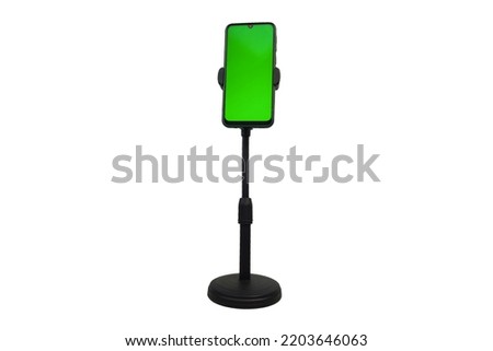 Phone mobile telephone with a vertical green screen in tram chroma key smartphone technology cell phone on white background isolate Royalty-Free Stock Photo #2203646063