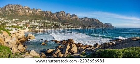 View of Camps Bay beach and Twelve Apostles from Maidens Cove. Cape Town, Western Cape, South Africa.