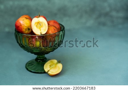 Fresh red apples in a glass vase on a gray background. High quality photo