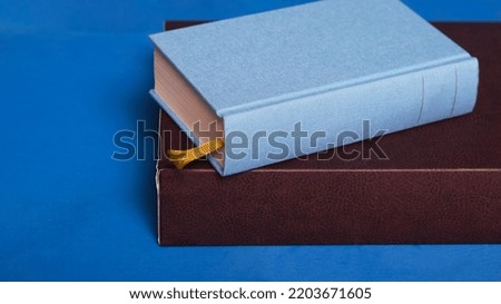 books and copy space on blue background
