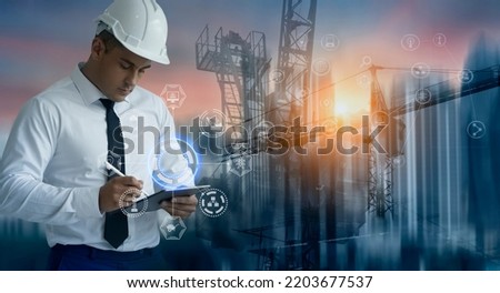 Double exposure engineering working with tablet and digital technology interfaces icon and construction cranes on city background, Smart industry and digital technology and IOT software concept. Royalty-Free Stock Photo #2203677537