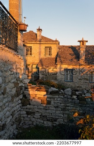 Stone houses of traditional architecture in Vitsa, Greece at sunset