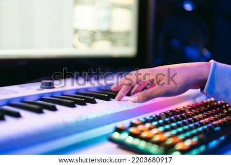 Producer, audio engineer uses a control panel and screen to record a track of a new album in a recording studio. Image producer, designer in working process Royalty-Free Stock Photo #2203680917