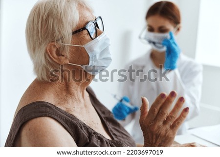 elderly woman wearing a medical mask immunization safety health care