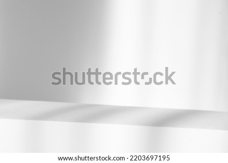 Abstract white studio with podium background for product presentation. Empty gray room with shadows of window. Display product with blurred backdrop.