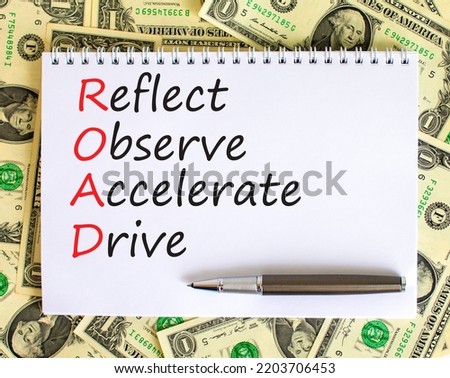 ROAD reflect observe accelerate drive symbol. Concept words ROAD reflect observe accelerate drive on white note, dollar background. Business ROAD reflect observe accelerate drive concept. Copy space.