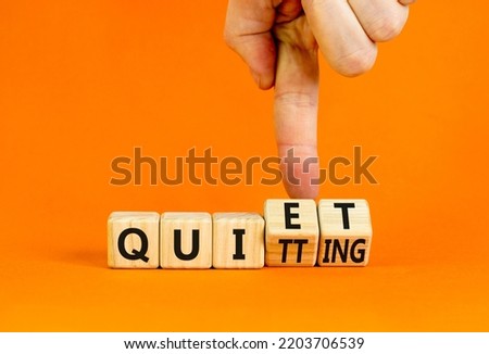 Quiet quitting symbol. Concept words Quiet quitting on wooden cubes. Businessman hand. Beautiful orange table orange background. Business quiet quitting concept. Copy space. Royalty-Free Stock Photo #2203706539