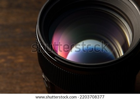Close up of camera lens on wooden table