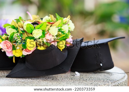 Graduation cap and  beautiful flower Royalty-Free Stock Photo #220373359