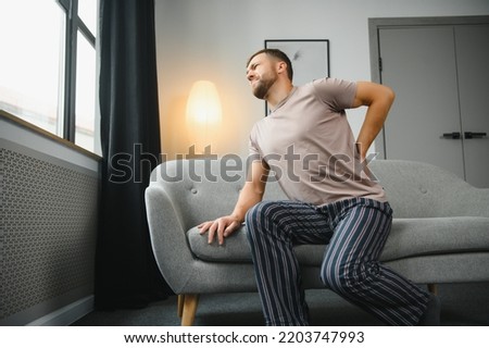 Back pain, kidney inflammation, man suffering from backache at home, health problems concept Royalty-Free Stock Photo #2203747993