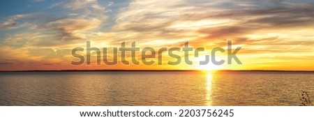 Orange sunset sky. sky for background or sunrise and cloud at morning. Dramatic sunset sky with clouds. Dramatic sunset over sea. Image of cloud sky on evening time. Royalty-Free Stock Photo #2203756245