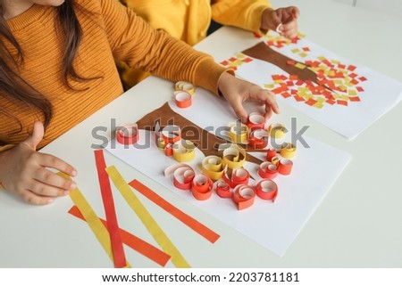 Children make an application, top view, close-up hands. Autumn master class Royalty-Free Stock Photo #2203781181