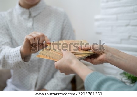 Psychologist uses metaphorical associative cards in a session with a patient. Close-up of female hands.