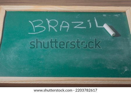 Green chalkboard with the word "Brazil" written with white chalk,copy space below brazil concept.