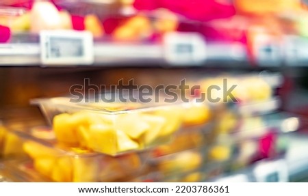 Packages with fresh fruits displayed in a commercial refrigerator
