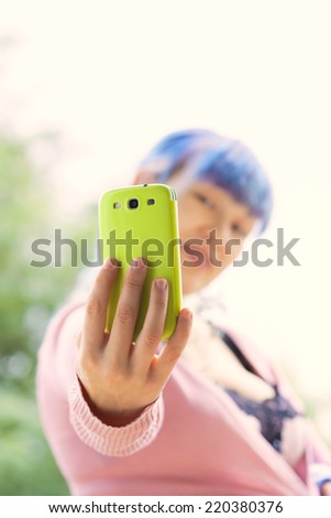Young beautiful woman taking selfie on mobile phone