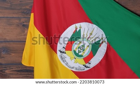 State flag of Rio Grande do Sul, Brazil, on wooden background. Gaucho day, farroupilha week.