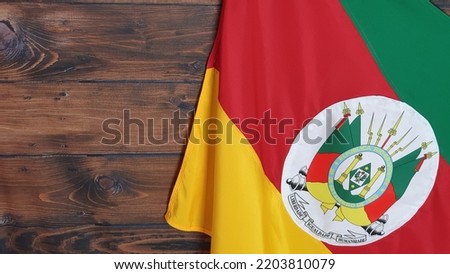 State flag of Rio Grande do Sul, Brazil, on brown background. Gaucho day, farroupilha week.