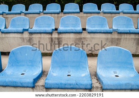 Empty seats in an old football stadium.