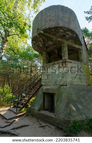 Old concrete infantry bunker in the woods of Hel, Poland. Old military fortification from World War Two and Cold War. Guard outpost on the hill. Sign saying Unauthorized: No entry 