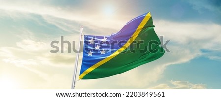 Solomon Islands national flag waving in beautiful sky.