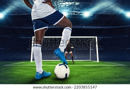 Soccer scene at night match with player kicking the penalty kick Royalty-Free Stock Photo #2203855147