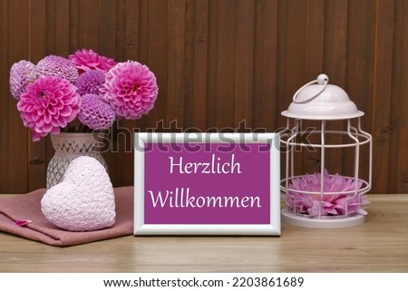  Frame with flowers and the lettering Herzlich Willkommen.
Herzlich Willkommen translated Welcome.