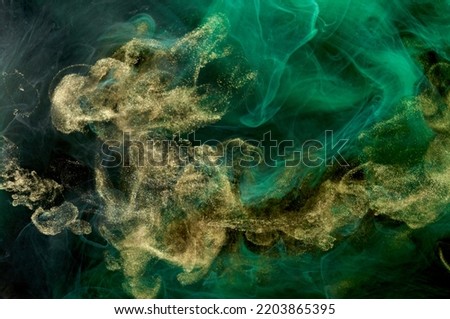 Golden sparkling abstract background, luxury green smoke, acrylic paint underwater explosion, cosmic swirling ink Royalty-Free Stock Photo #2203865395