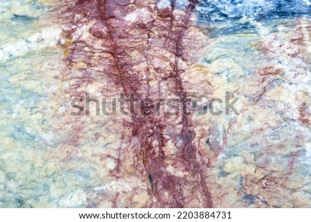 Natural stone marble rock surface by the stream.  stone marble texture background.Selective focus.
