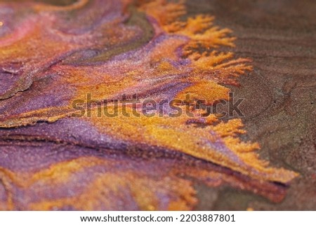 Abstract painting. Acrylic magic. Creative art. Purple orange liquid glitter blend