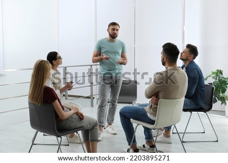 Psychotherapist working with group of drug addicted people at therapy session indoors Royalty-Free Stock Photo #2203895271