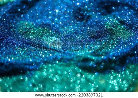 Shiny blue green glitter textured background