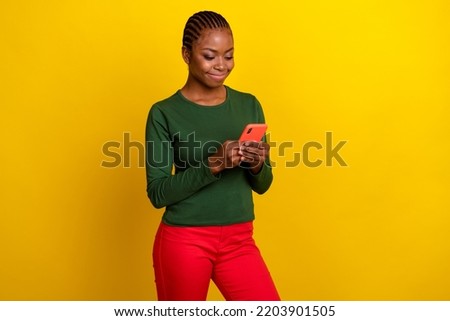 Photo of pretty charming young lady dressed green shirt communicating modern gadget isolated yellow color background