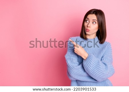 Portrait of impressed pretty lady look indicate finger empty space isolated on pink color background