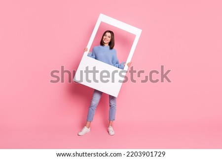 Full size photo of young pretty positive girl take shoot party holding white photo frame isolated on pink color background
