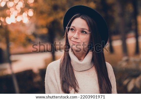 Photo of pretty positive lovely person imagine think spend free time stroll park outdoors