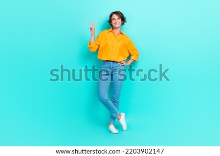 Full length photo of pretty lady stand empty space show hi symbol her boyfriend dressed trendy outfit isolated on cyan color background