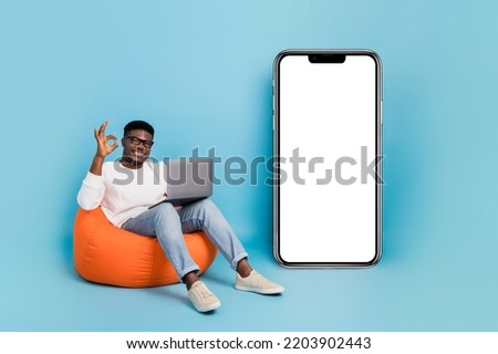 Full length photo of positive guy show okey symbol empty space ui panel isolated on blue color background