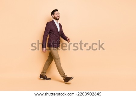 Full body picture of intelligent businessman go to workplace workstation isolated on beige color background