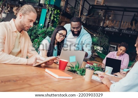 Photo of pretty confident businesspeople having upgrading courses indoors workplace workshop loft