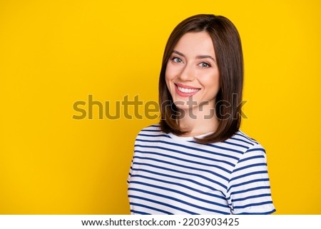 Portrait of pretty adorable gorgeous girl with bob hairstyle wear striped t-shirt toothy smiling isolated on yellow color background