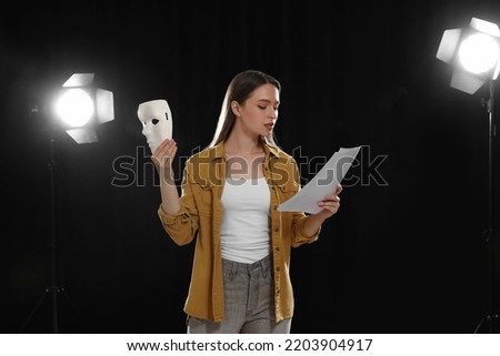 Professional actress reading her script during rehearsal in theatre Royalty-Free Stock Photo #2203904917
