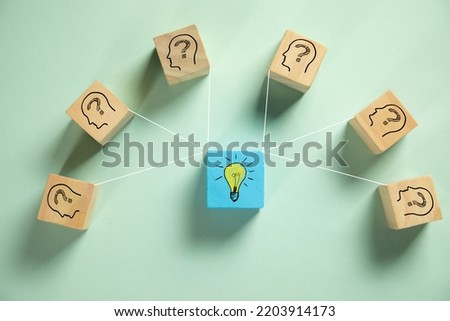 Creative idea. Wooden cube blocks with human head symbols with question mark and light bulb symbol